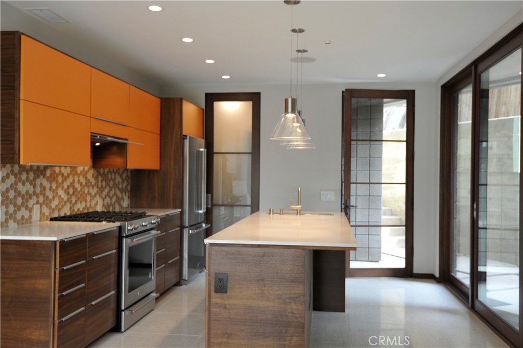 a kitchen with a sink and a stove top oven