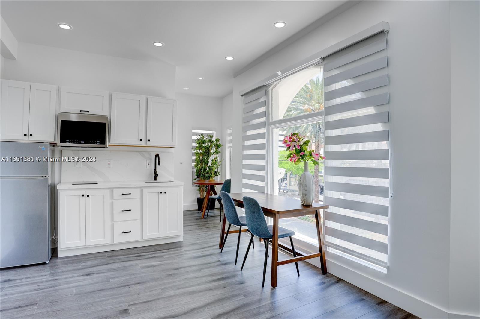 a kitchen with furniture and wooden floors