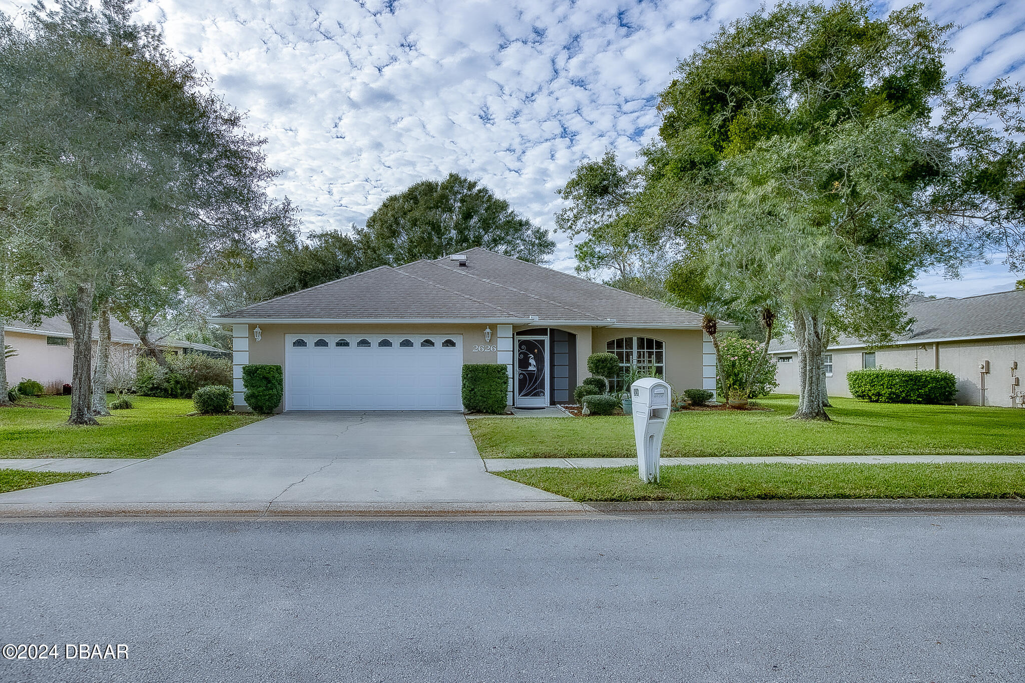 a front view of a house with a yard and garage