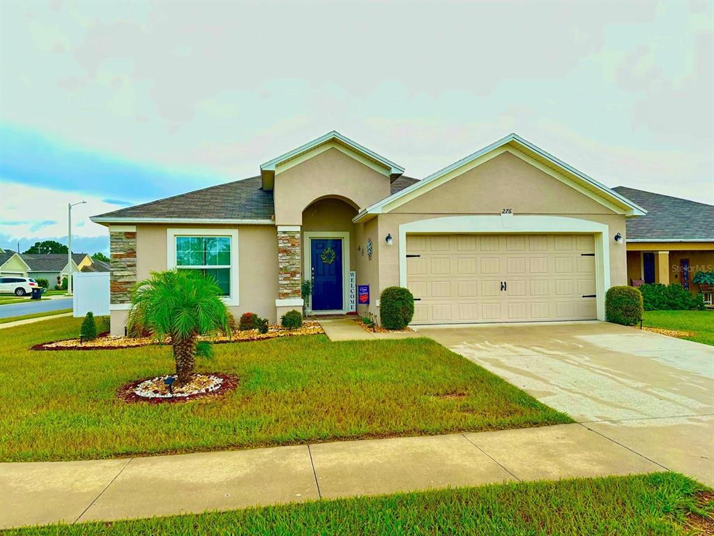 a front view of a house with a yard and garage