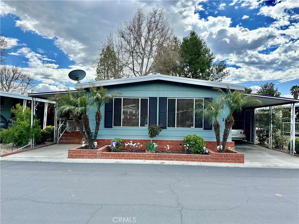 a view of a building with sitting area and garden