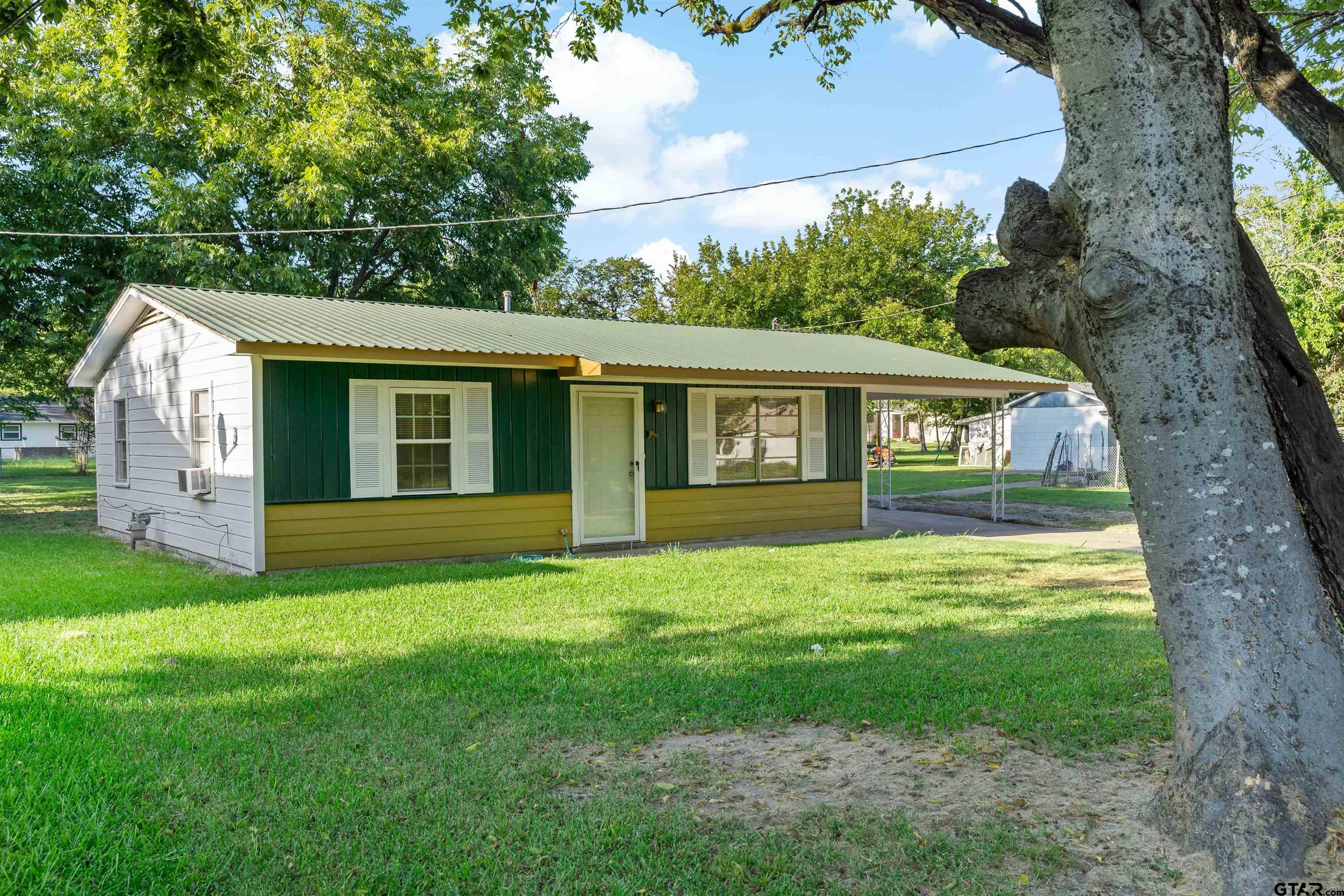 a view of house with backyard