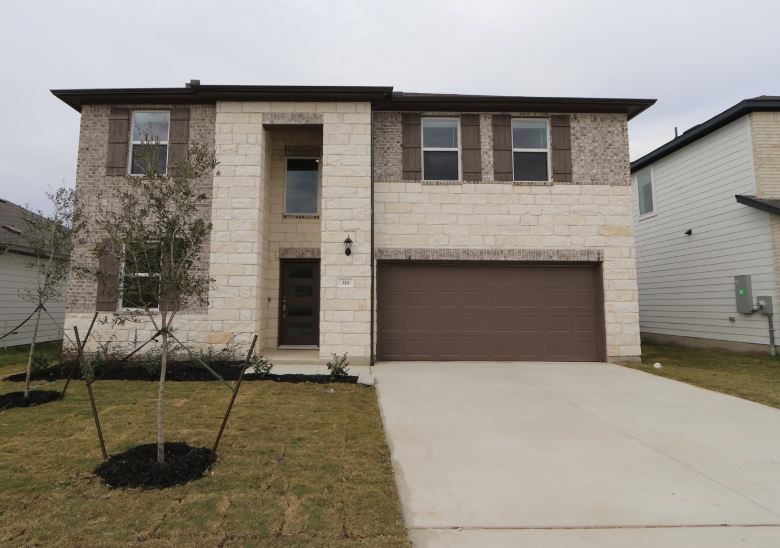 a front view of a house with garage