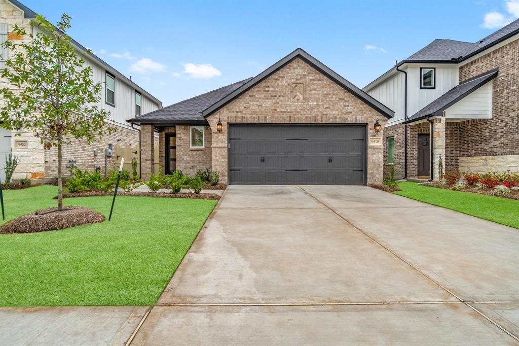 a front view of a house with a yard and garage