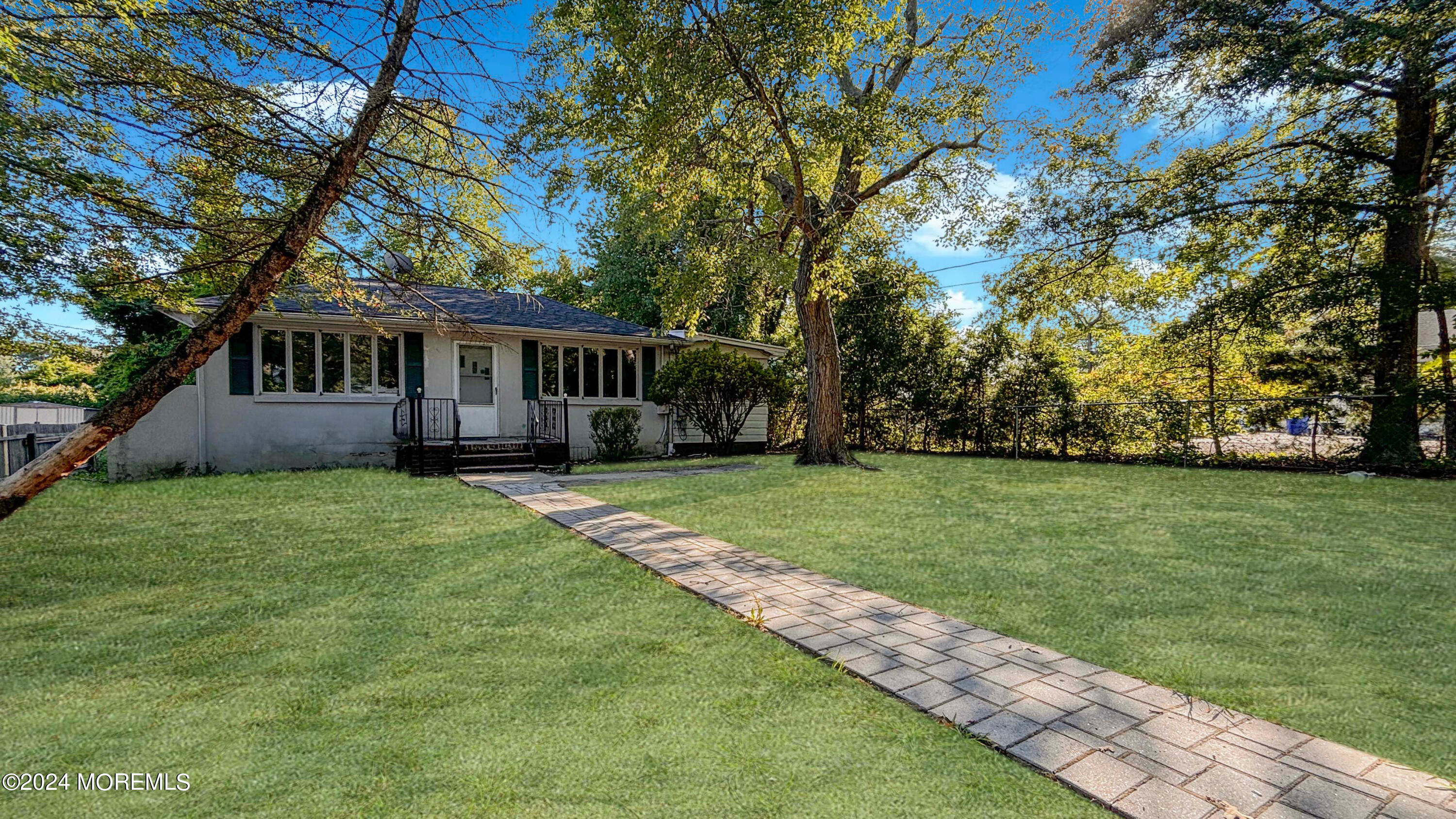 a view of house with backyard space and garden