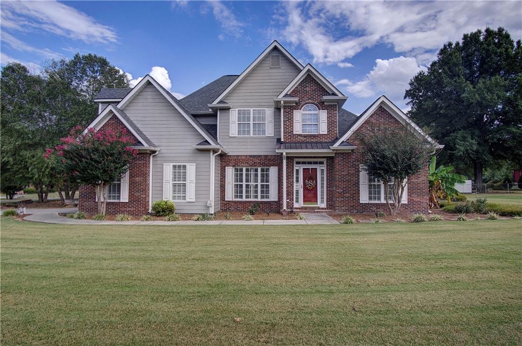 a front view of a house with a garden