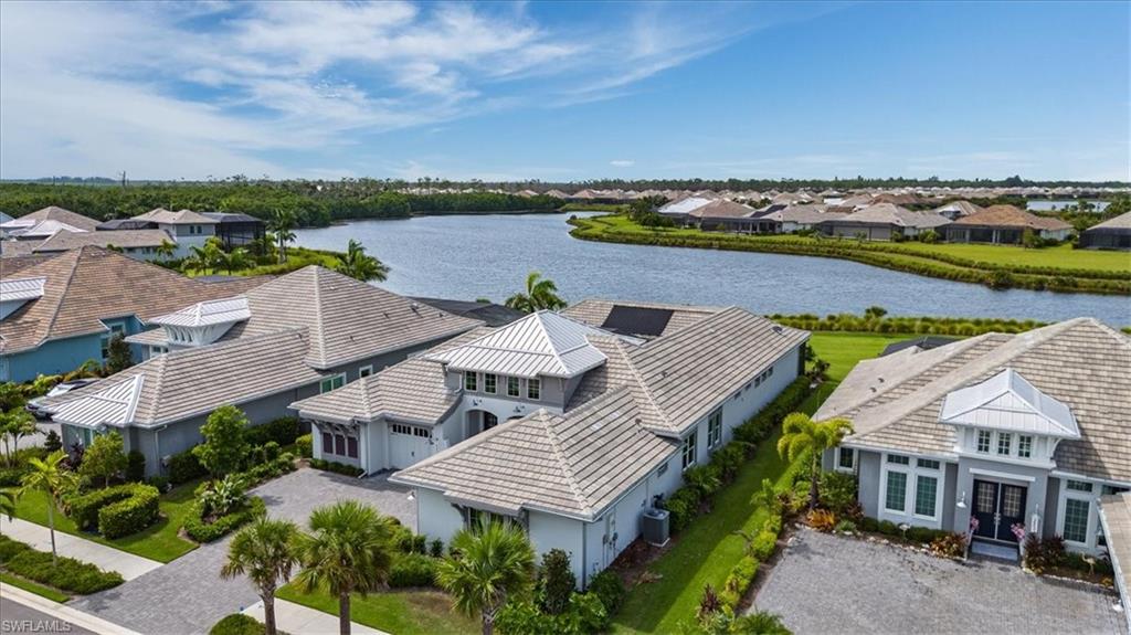 an aerial view of a house with a garden and lake view