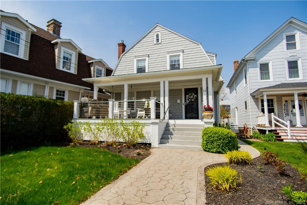 a front view of a house with garden and porch