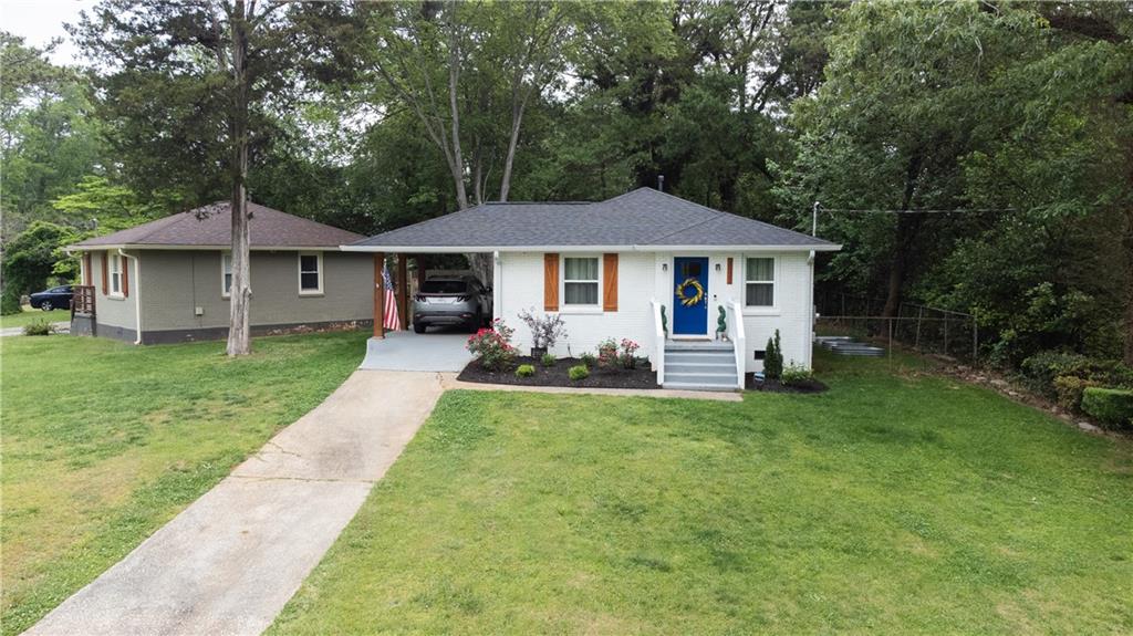 a view of a house with a yard porch and sitting area