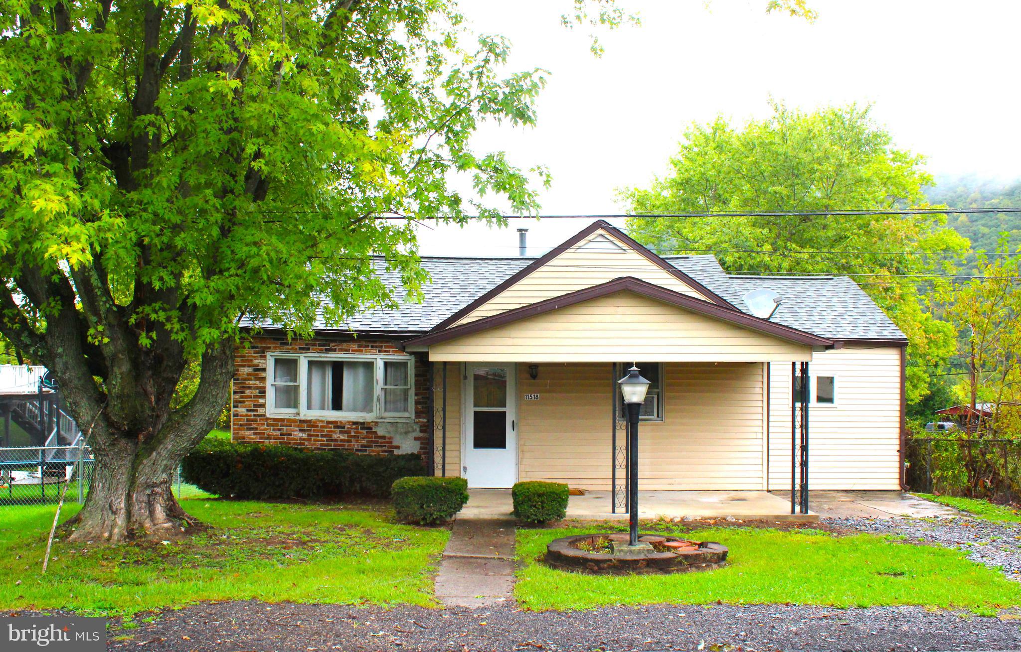 a front view of a house with a yard and porch