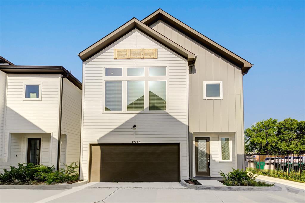 a front view of a house with garage