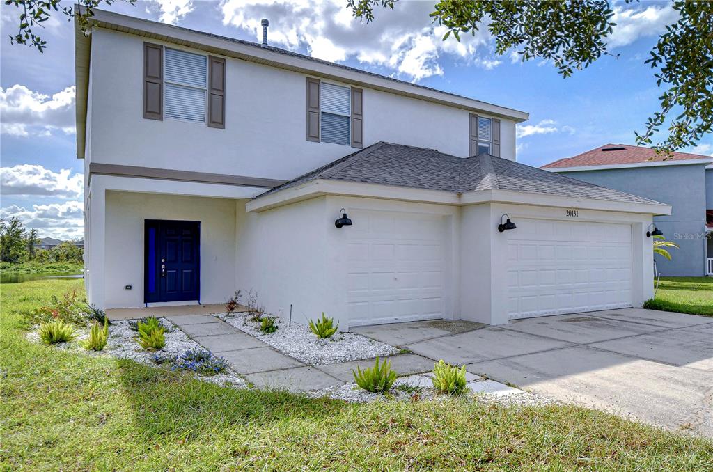 a front view of a house with a yard and garage