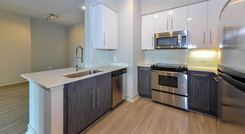 a kitchen with a sink and steel appliances