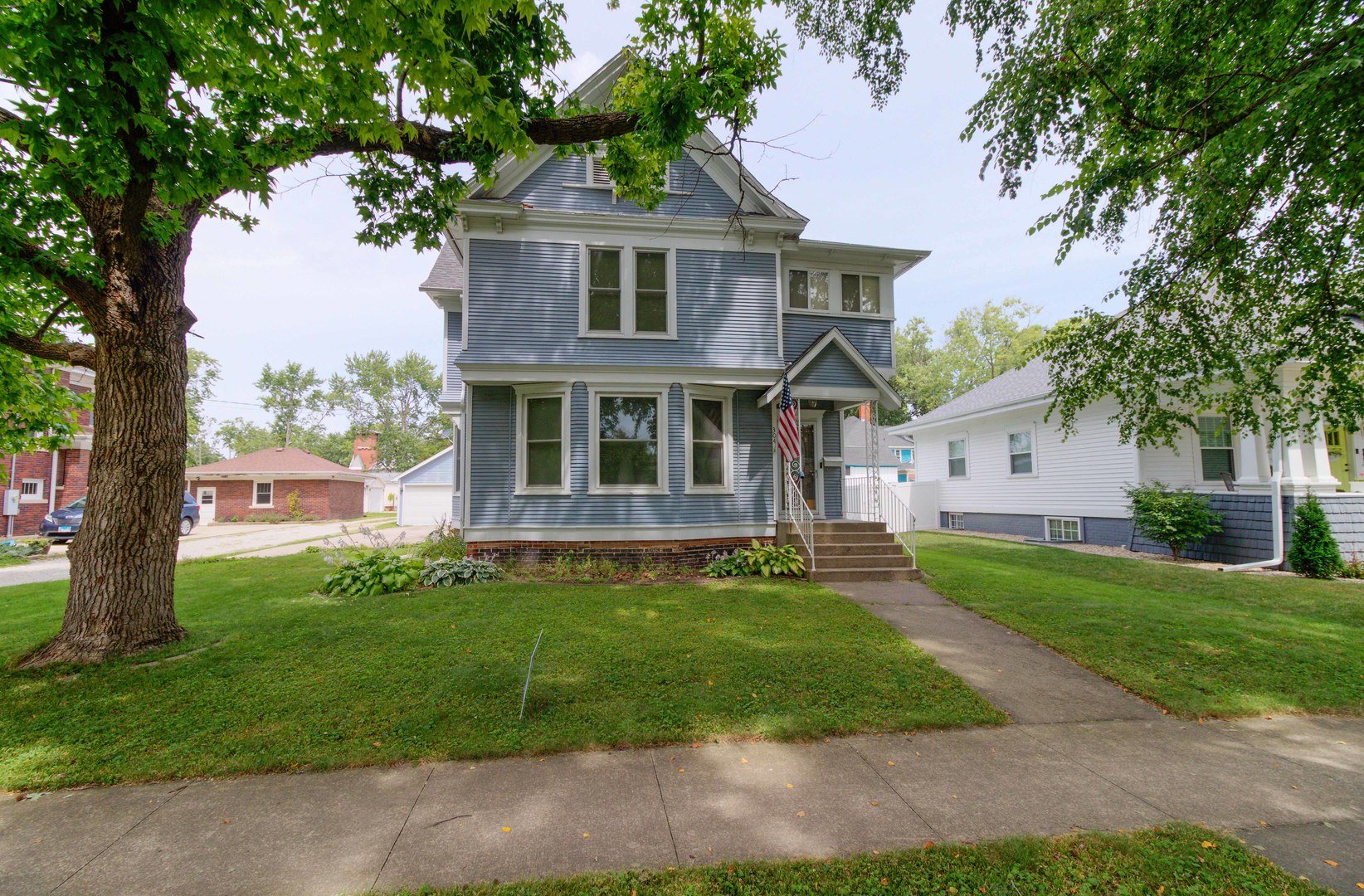 a front view of a house with a garden