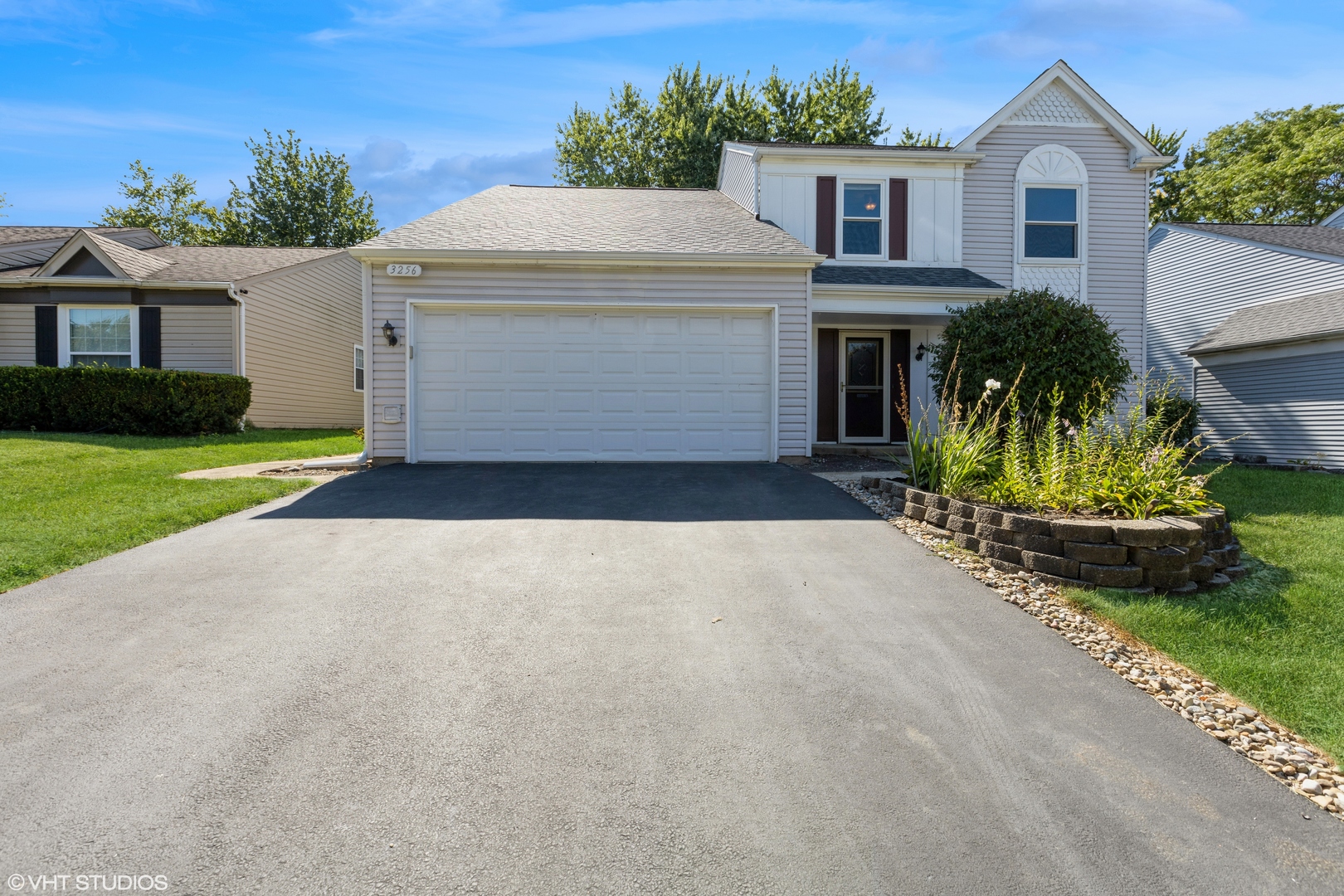 a front view of a house with a yard and garage