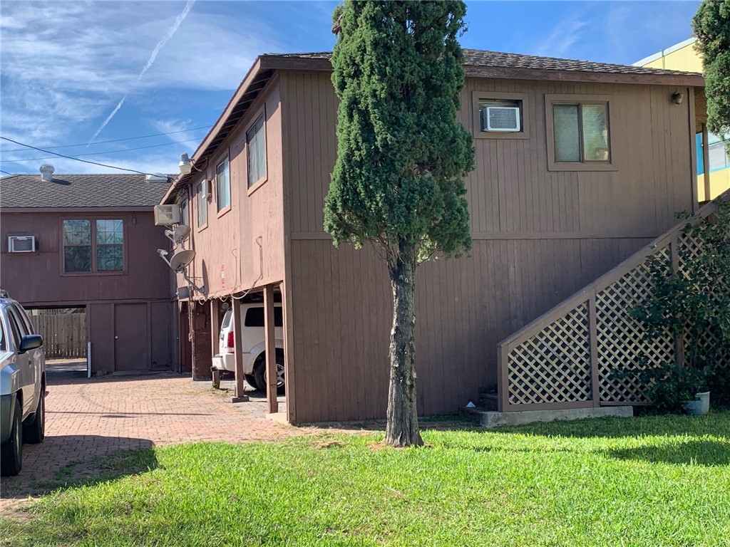 a front view of a house with a yard and a garage