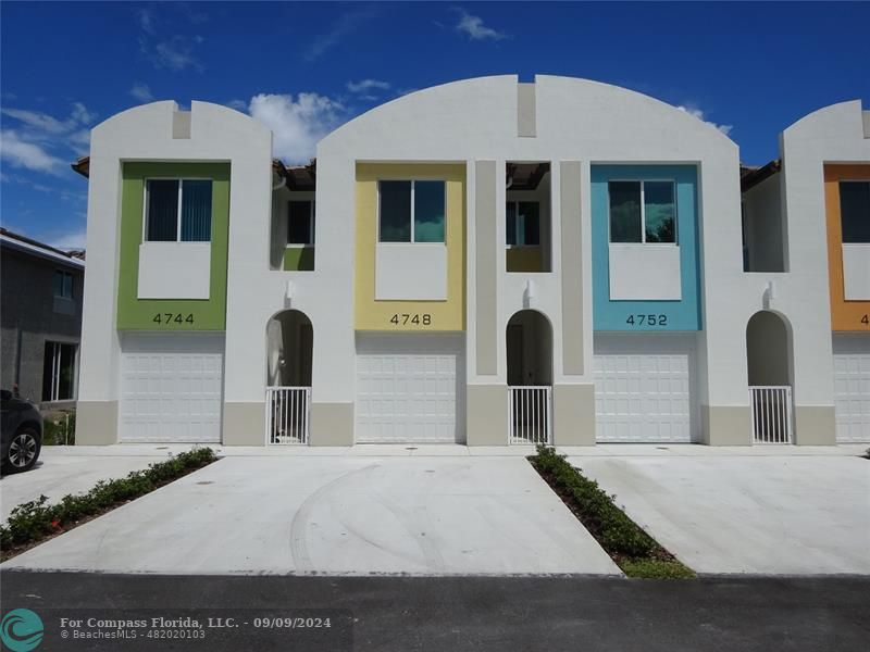 a front view of a house with white walls