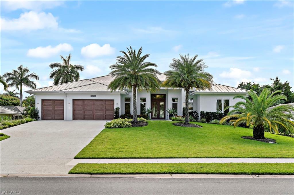 a view of a house with a swimming pool and a yard