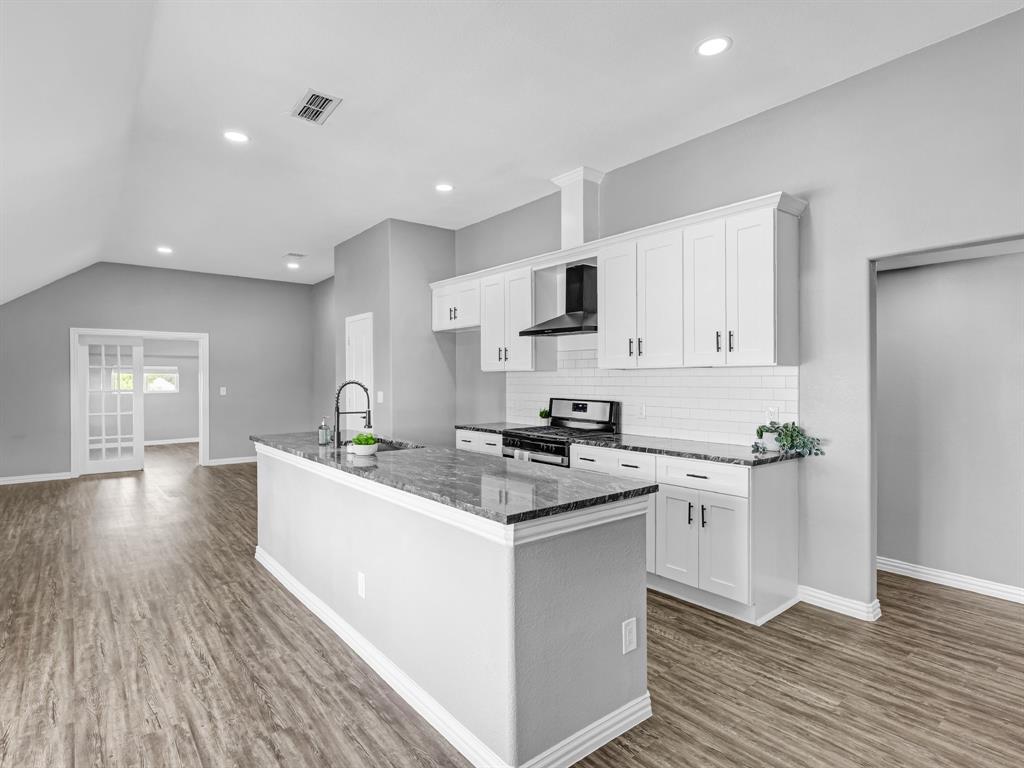 a kitchen with stainless steel appliances granite countertop a sink stove and refrigerator