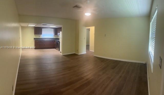 a view of a kitchen with a sink and a refrigerator