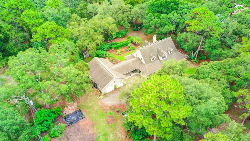 an aerial view of a house with a yard