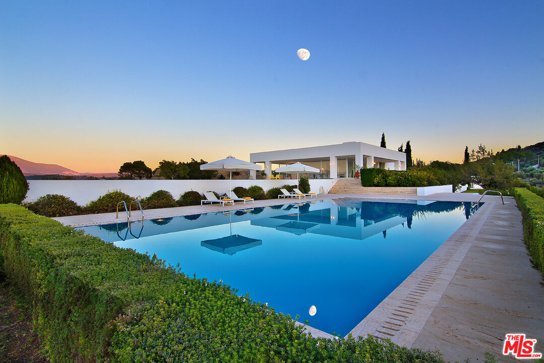 a view of a house with outdoor space and sitting area