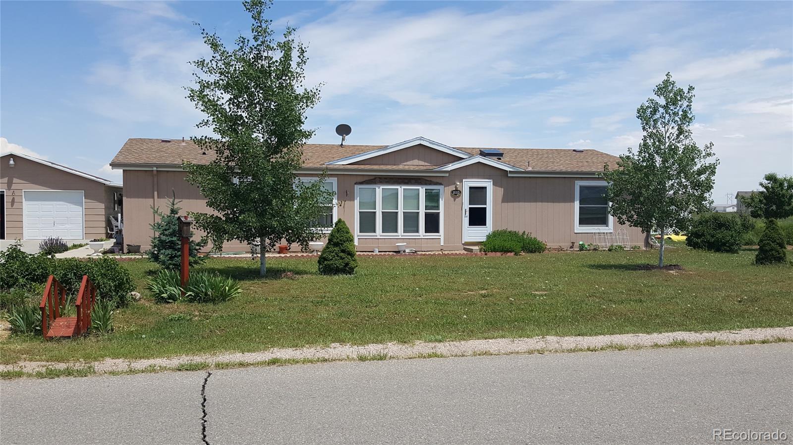 a front view of a house with a yard and a garage