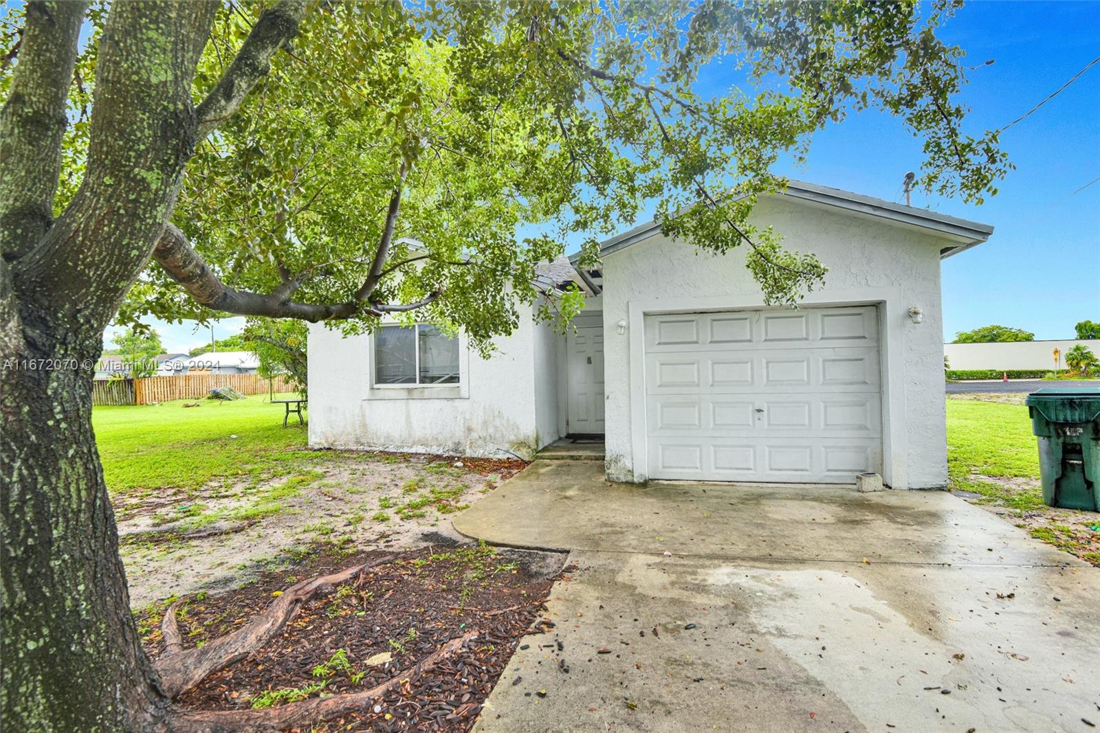 a view of a house with a yard and garage