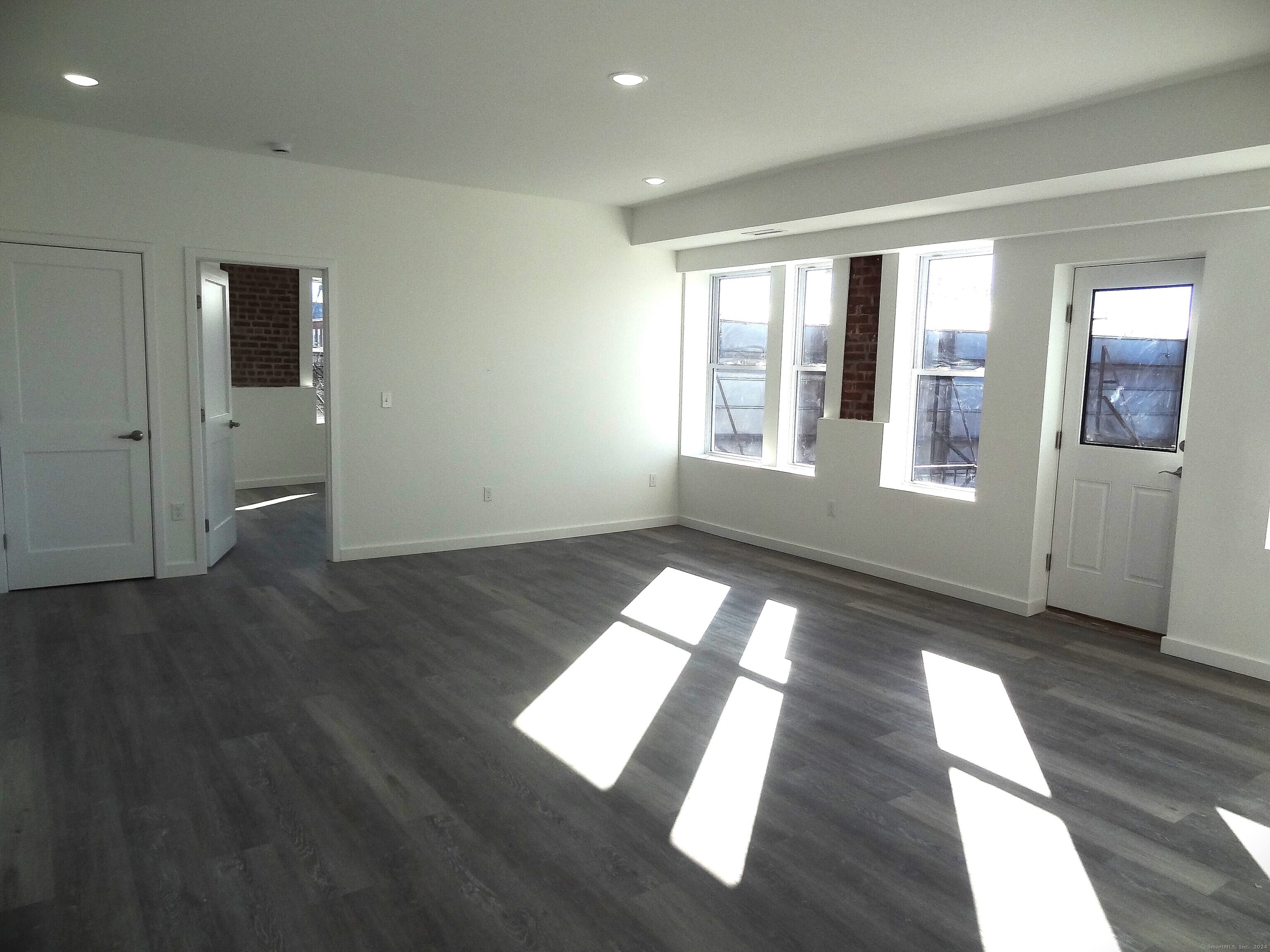 a view of wooden floor and windows in an empty room