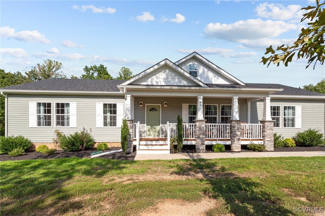 a front view of house with yard outdoor seating and green space