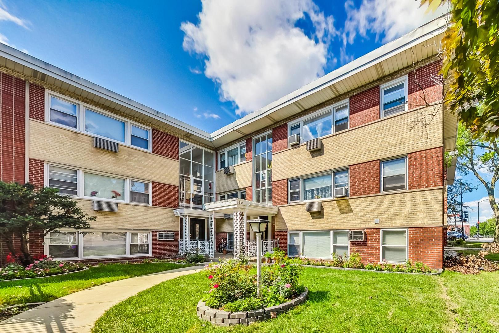 a large building with a yard in front of it