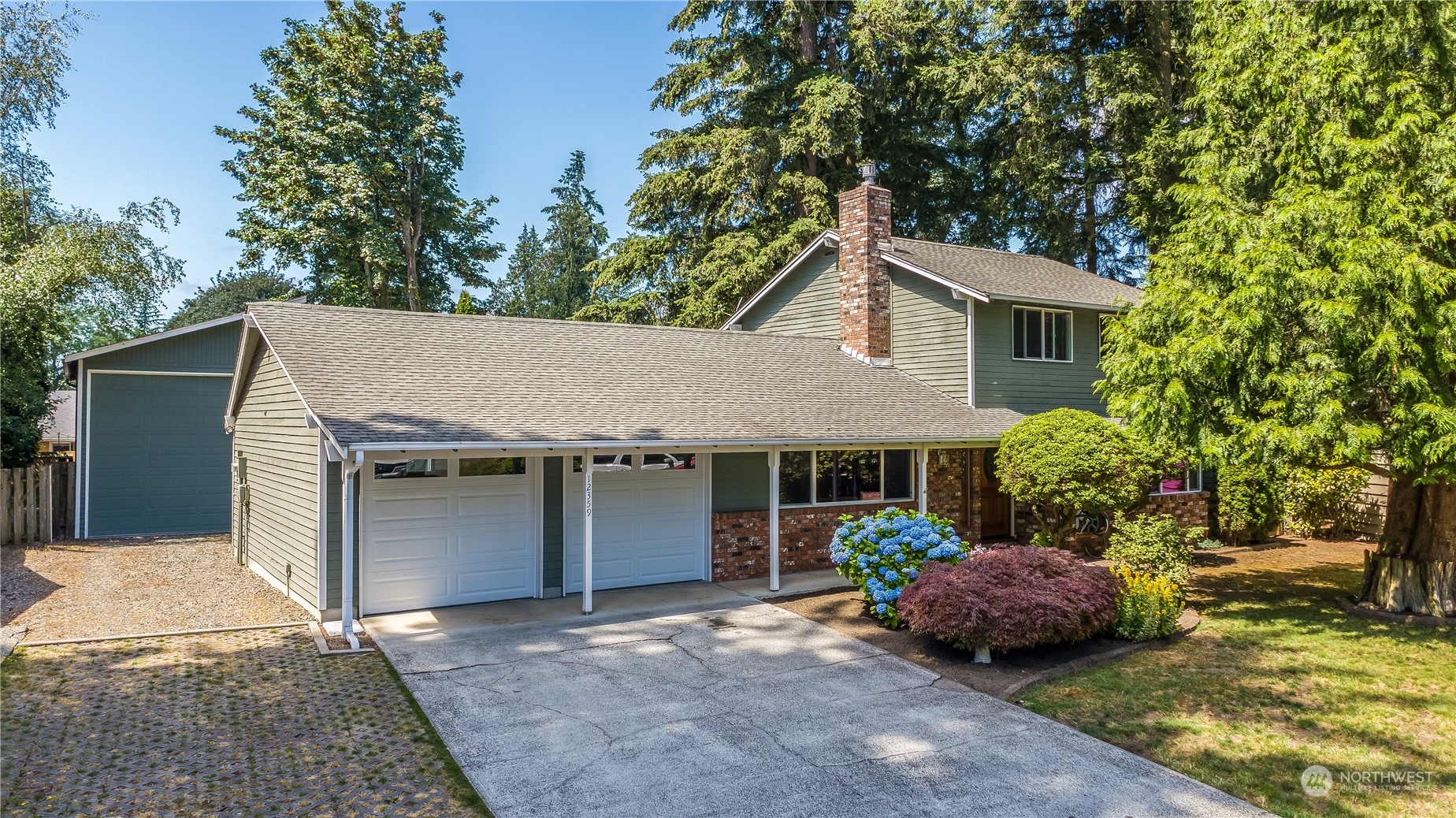 a view of a house with a patio and a yard