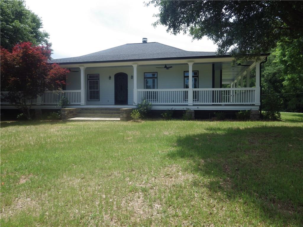 a view of house with backyard space and garden