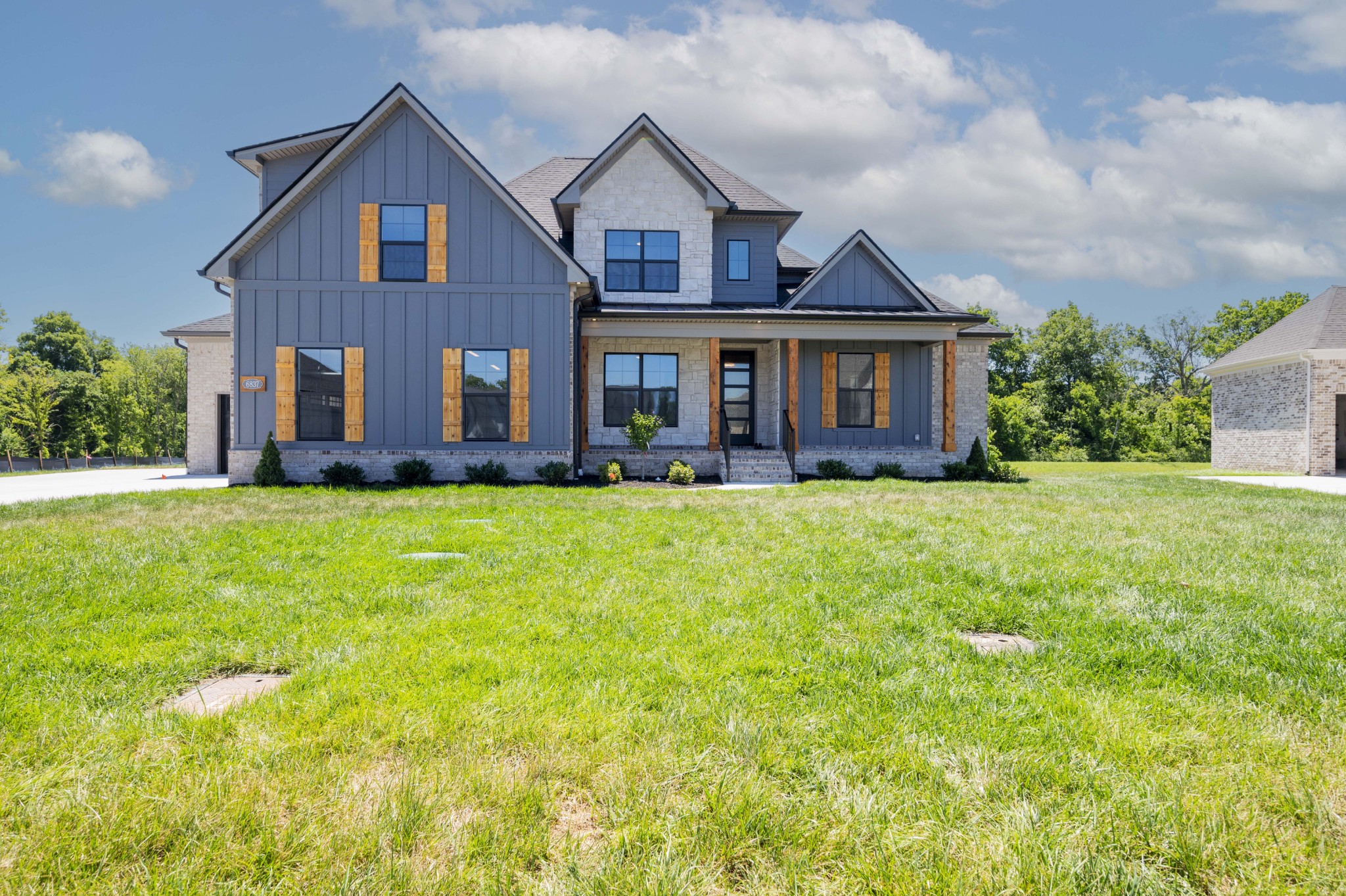 a front view of house with yard and green space