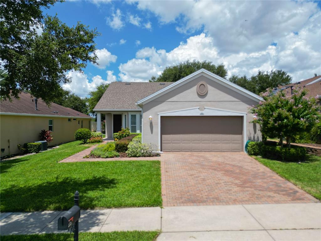 a front view of a house with a yard and garage