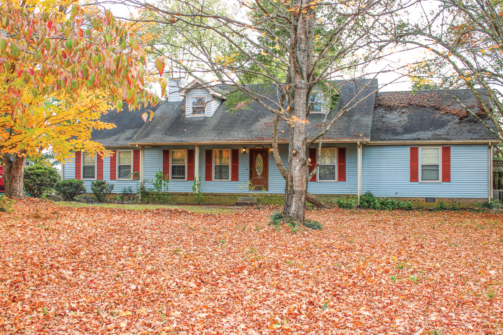 a front view of a house with a garden