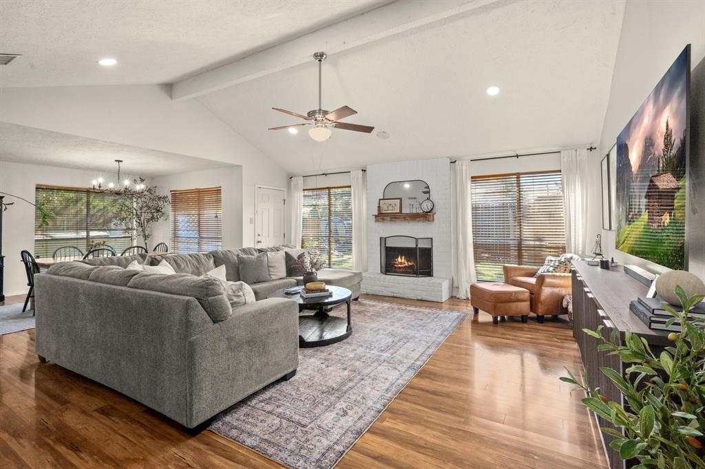 a living room with furniture large window and a fireplace