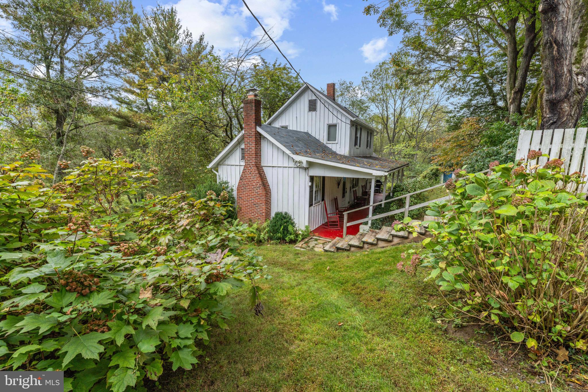 a view of a house with yard and tree s