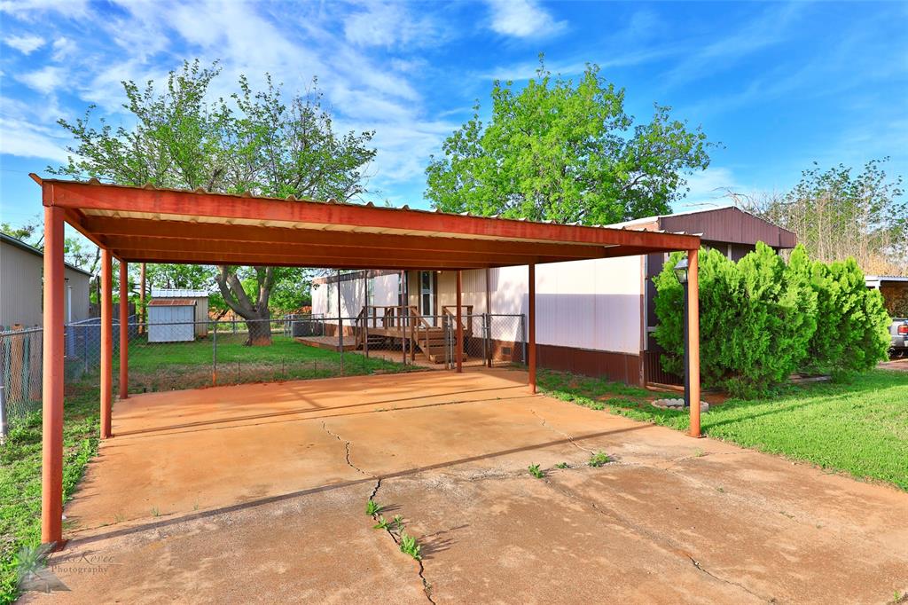 a backyard of a house with yard table and chairs