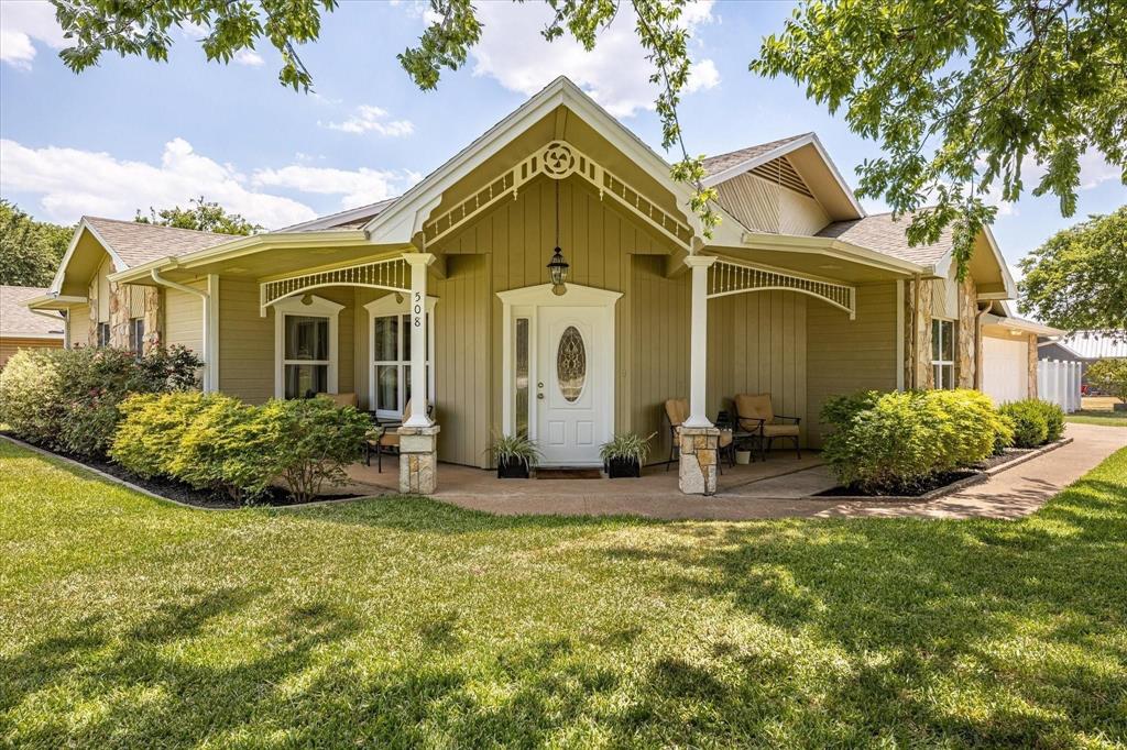 a front view of a house with garden