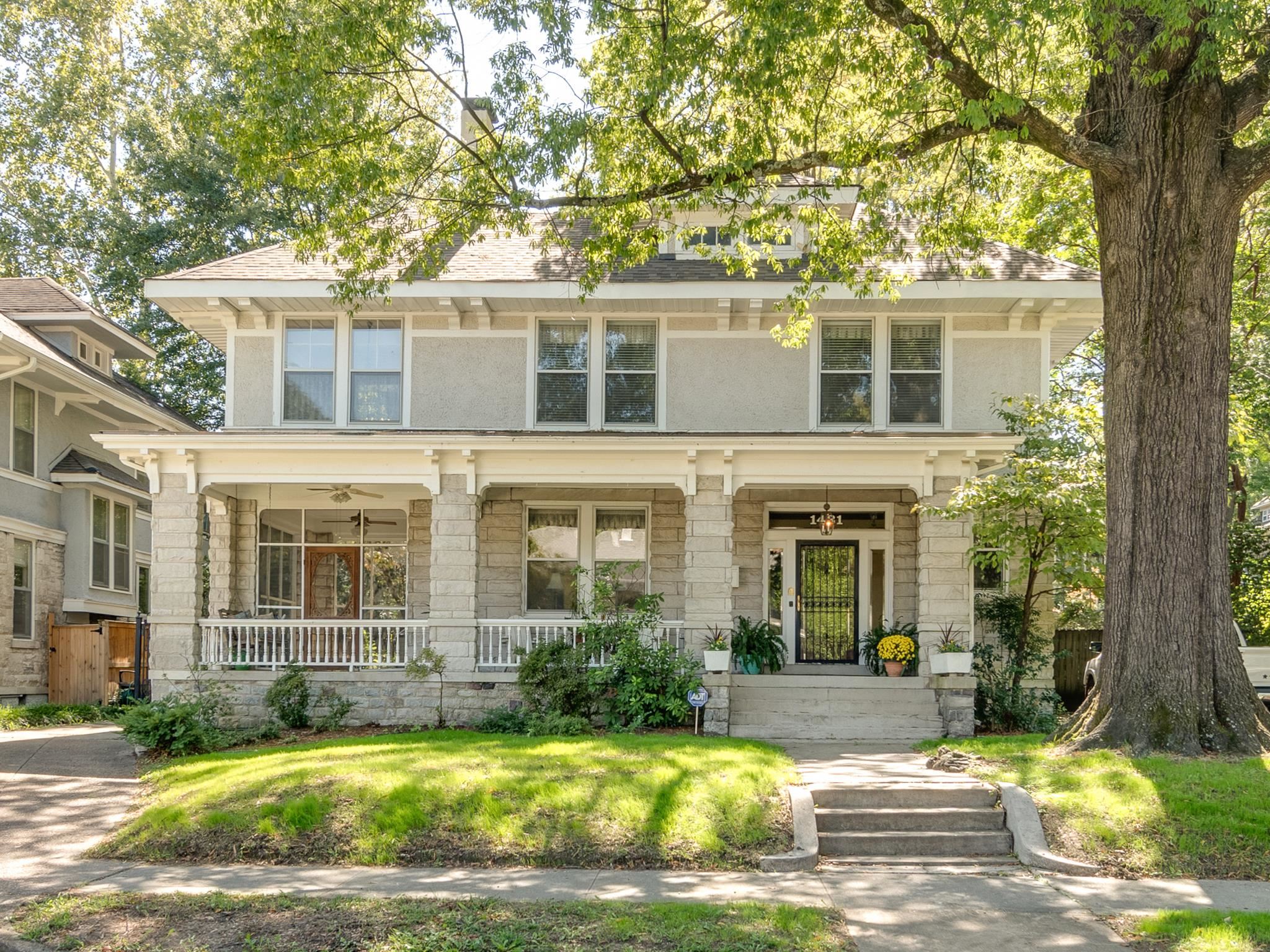 View of front of house featuring covered porch and screened-in porch