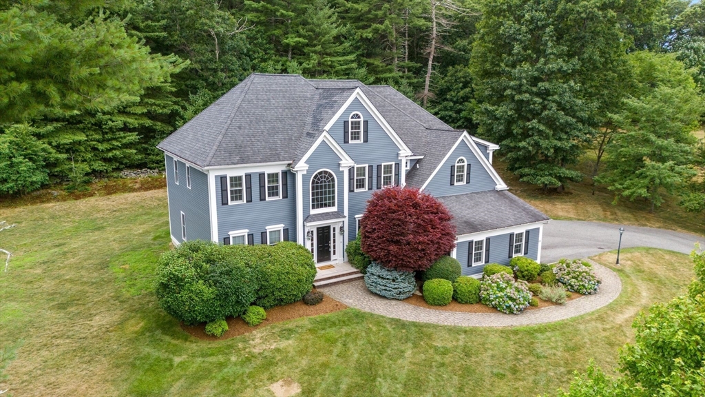 a aerial view of a house next to a yard