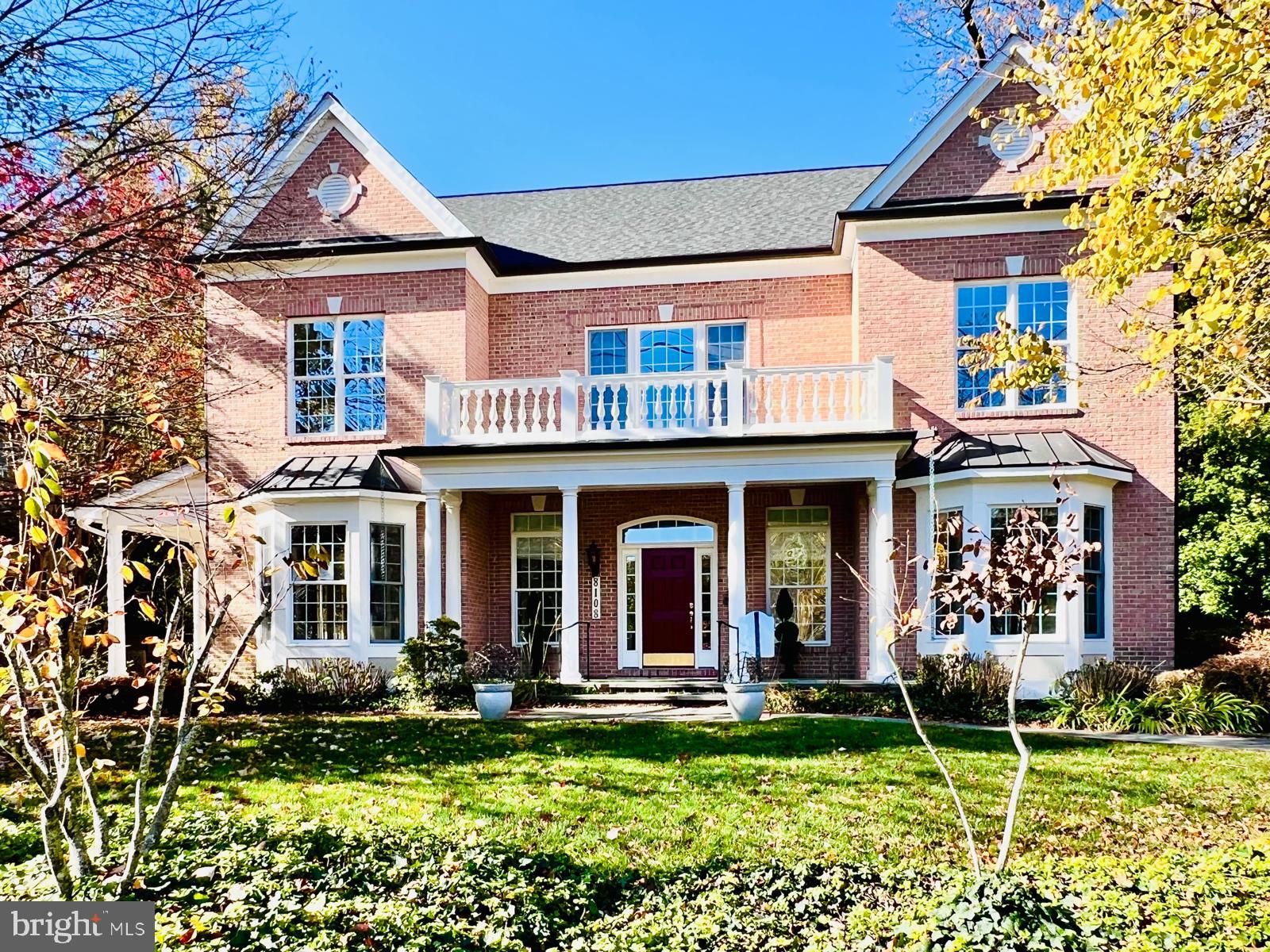 front view of a brick house with a yard