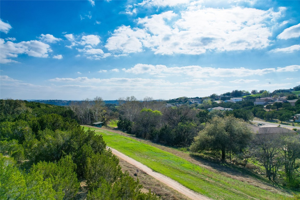 a view of a city with lush green forest