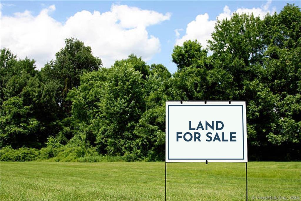 a sign broad on white wooden fence