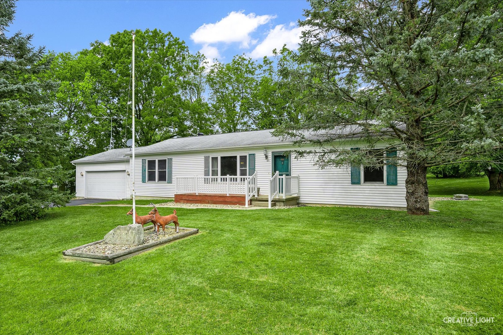 a view of a house with a backyard and a tree