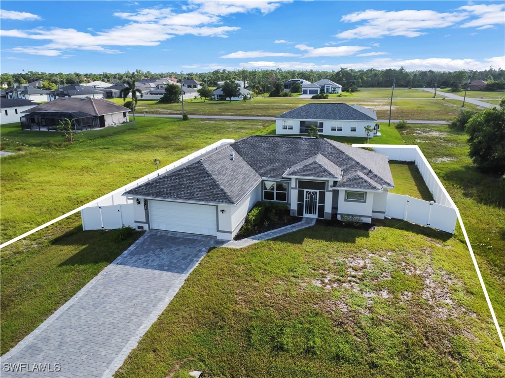 an aerial view of a house with a big yard