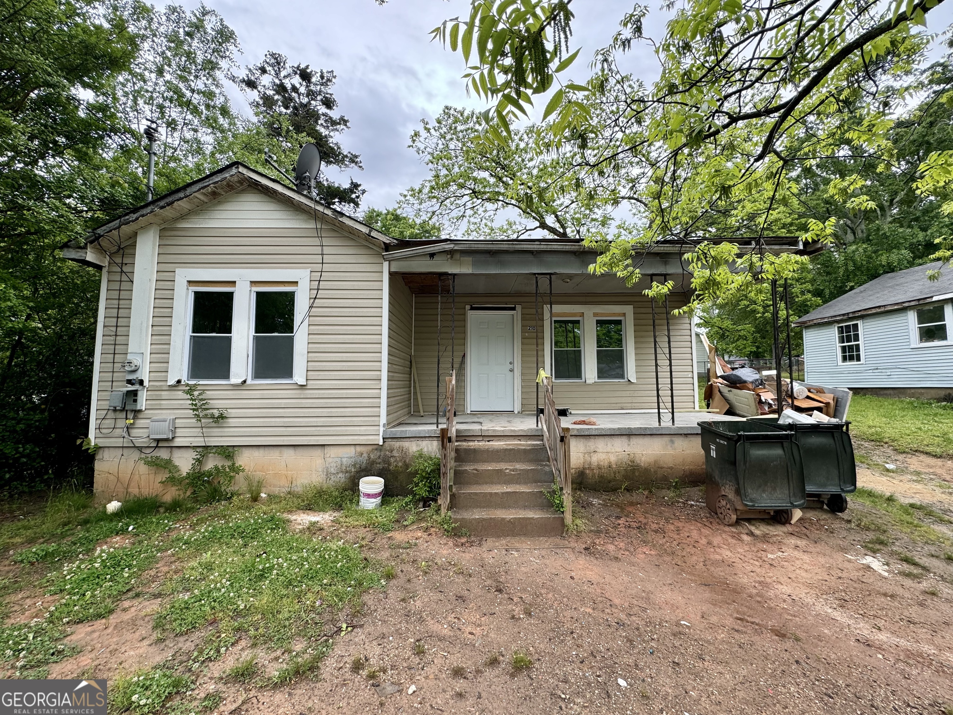 a view of a house with a yard and sitting area