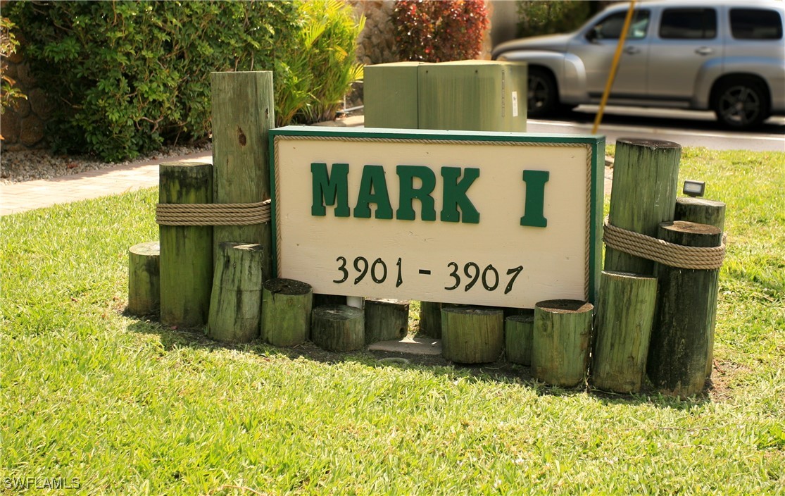 a view of a street sign under a large tree