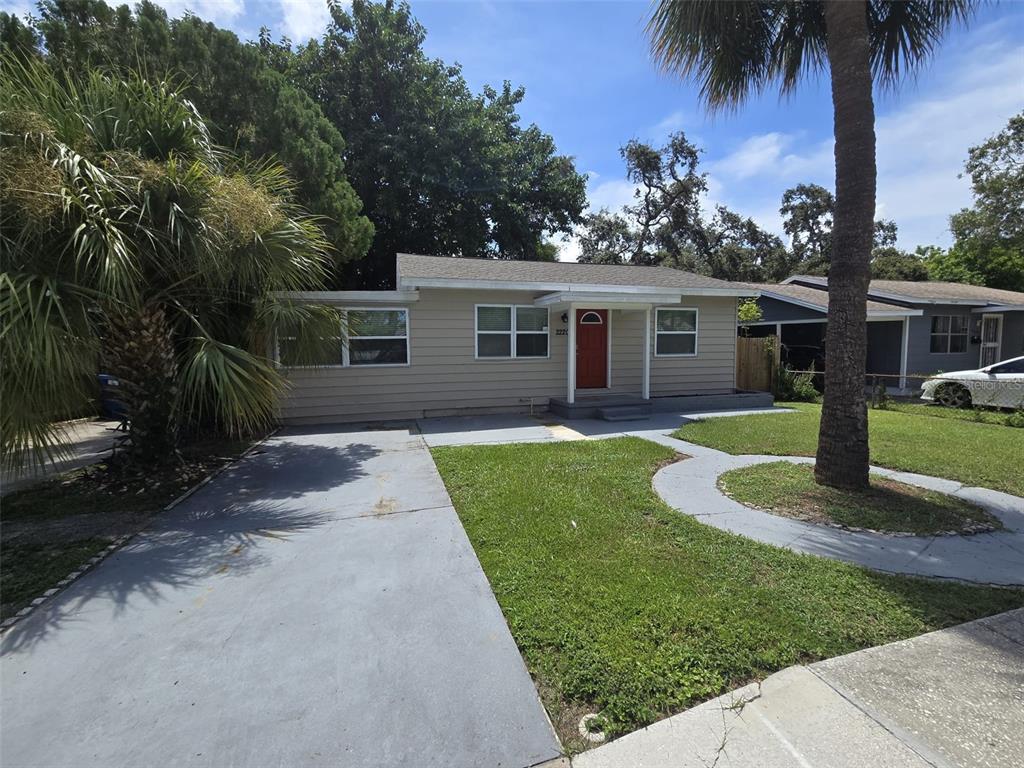 a front view of house with yard and green space